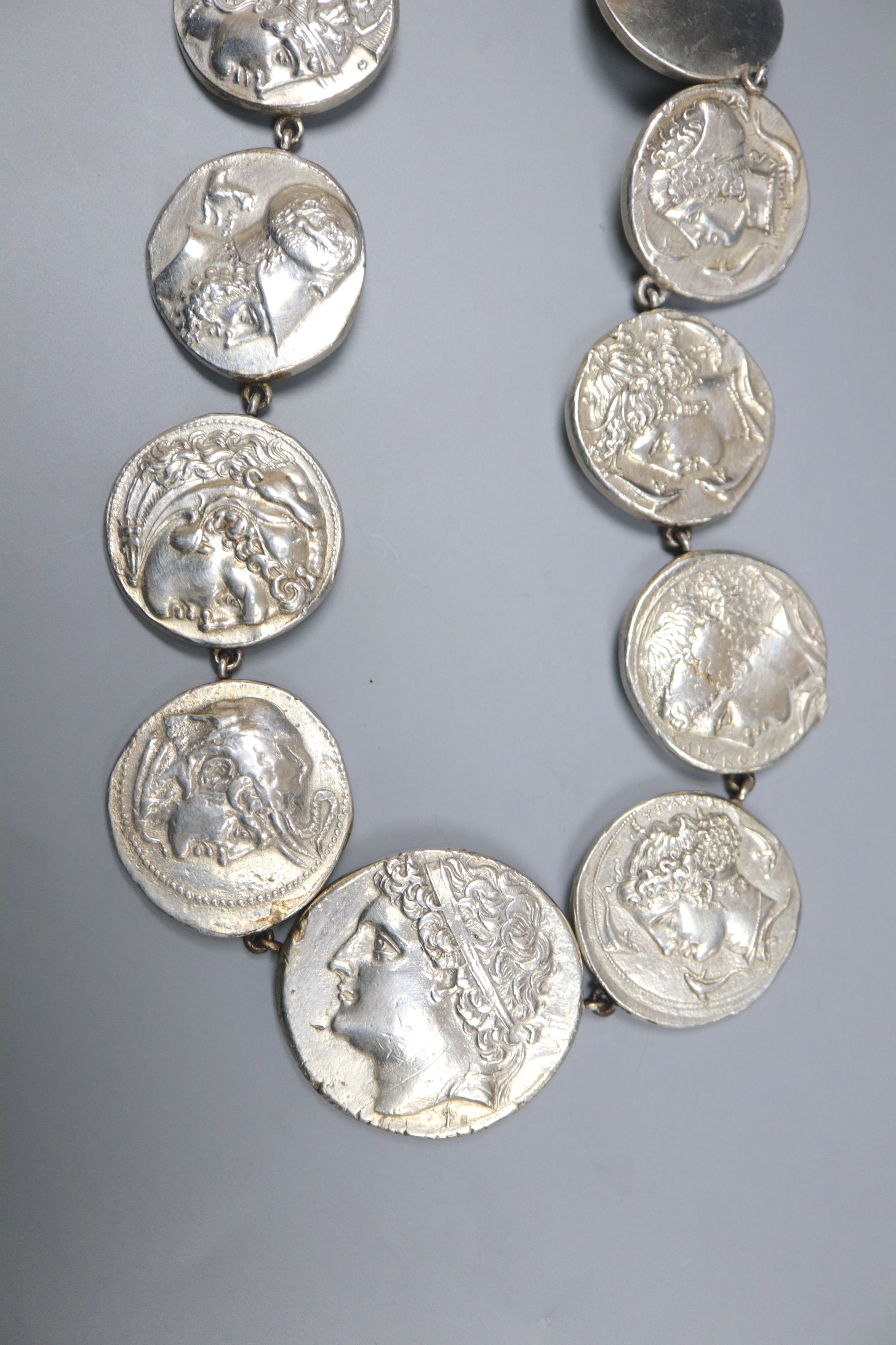 A continental white metal overlaid copper? graduated antique coin style medallion, necklace, 48cm, gross 101 grams.